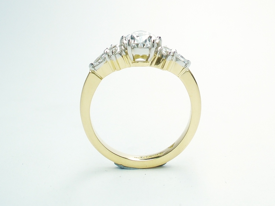 A 7 stone pear shaped, brilliant cut and marquise cut Lab grown diamond ring mounted in 18ct yellow gold and platinum.