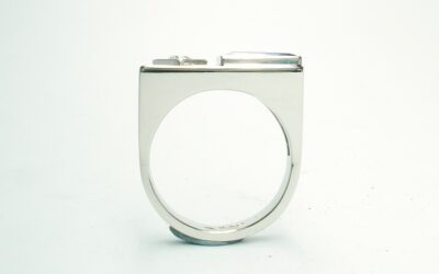A 2 stone baguette cut Tanzanite and round brilliant cut diamond ring, mounted in platinum with a plateau top.