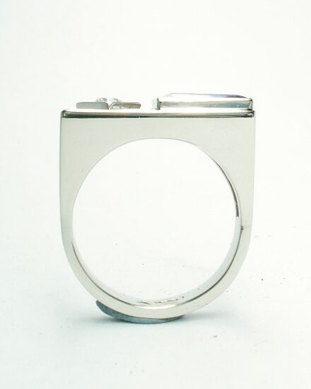 A 2 stone baguette cut Tanzanite and round brilliant cut diamond ring, mounted in platinum with a plateau top.
