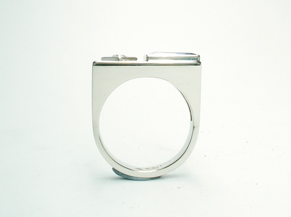 A 2 stone baguette cut Tanzanite and round brilliant cut diamond ring, mounted in platinum with a plateau top.