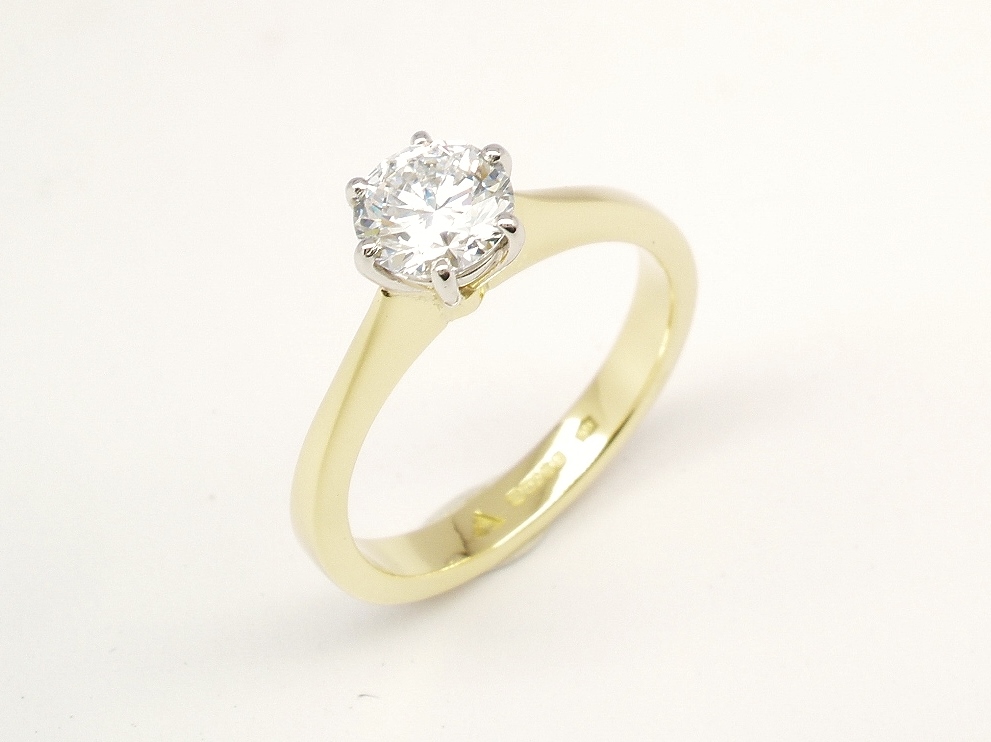A single stone round brilliant cut Lab grown diamond ring mounted in 18ct. yellow gold and platinum