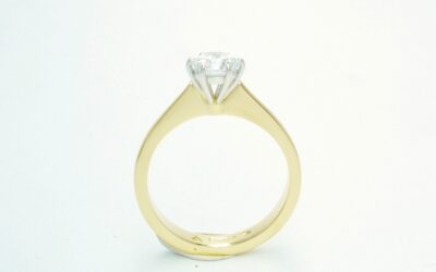 A single stone round brilliant cut Lab grown diamond ring mounted in 18ct. yellow gold and platinum