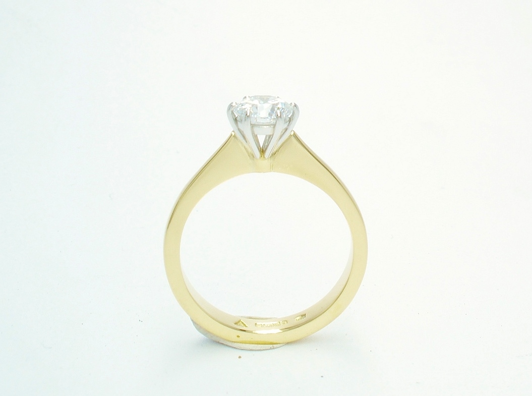 A single stone round brilliant cut Lab grown diamond ring mounted in 18ct. yellow gold and platinum
